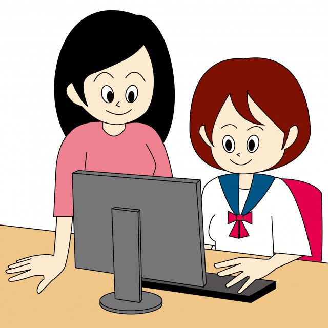 パソコンを教える女性の先生とパソコンを教わる女子学生