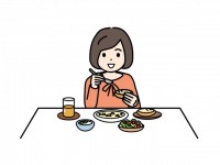 ご飯を食べる女の…